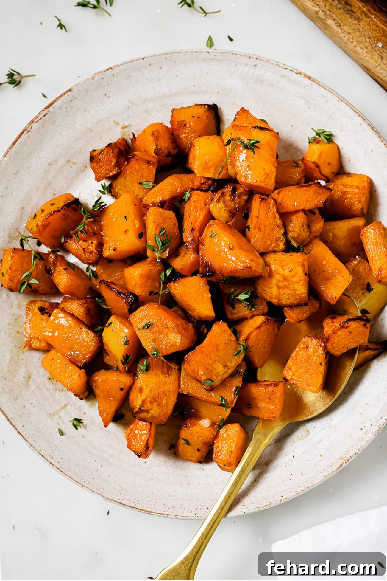 Golden Air Fryer Butternut Squash 12 Air fryer butternut squash topped with fresh thyme.