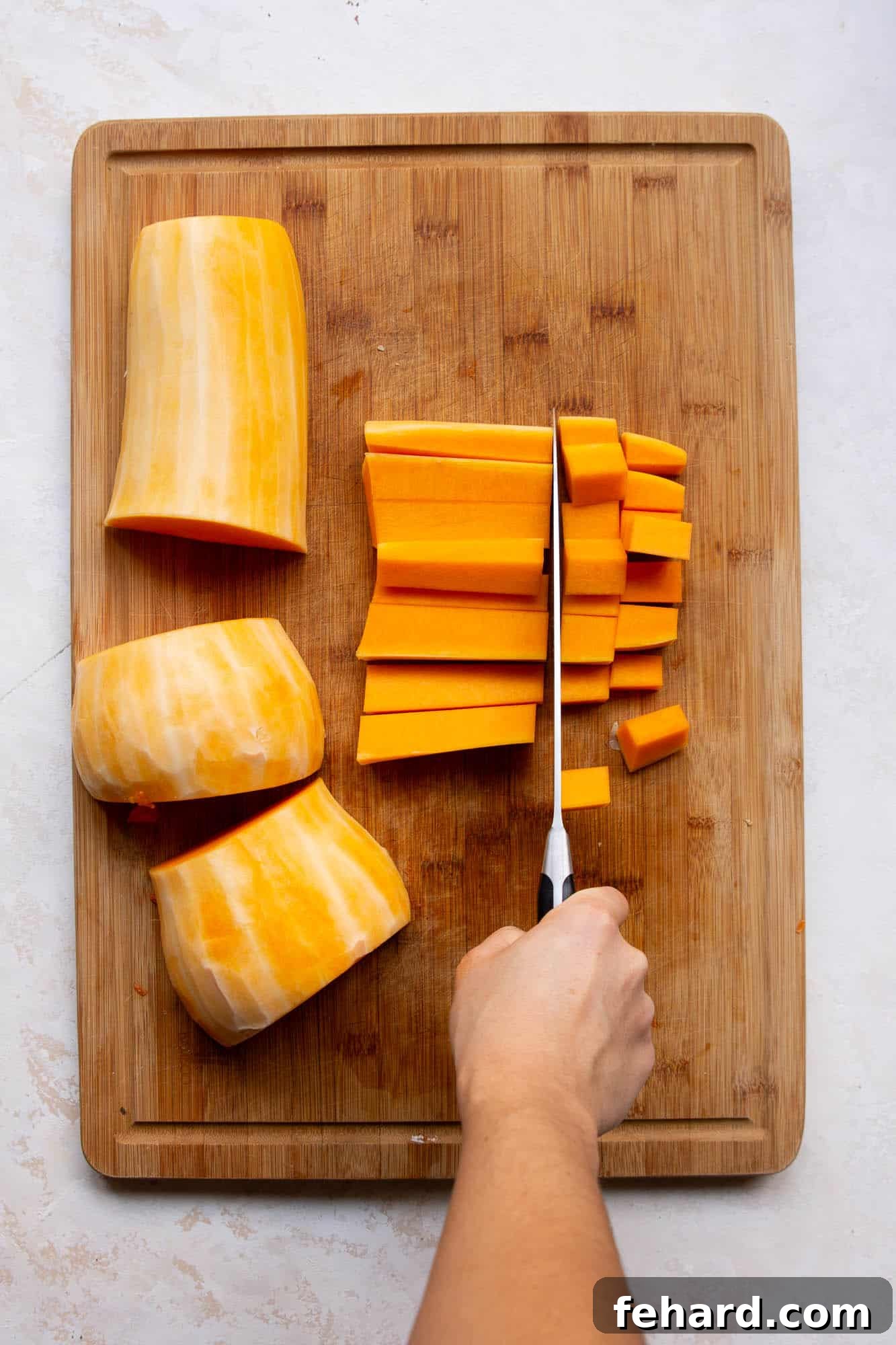 Golden Air Fryer Butternut Squash 5 Lay the squash half on its flat side, and cut into three parts. The half ring portions will be harder to cut very evenly.