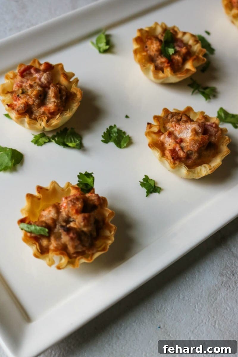 Sausage and Cream Cheese Mini Tarts on white platter