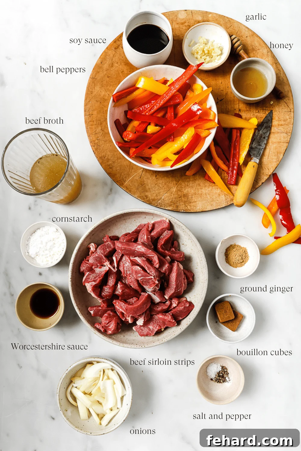 Melt-in-Your-Mouth Slow Cooker Pepper Steak 3 An overhead view of pre-measured ingredients on a white countertop.