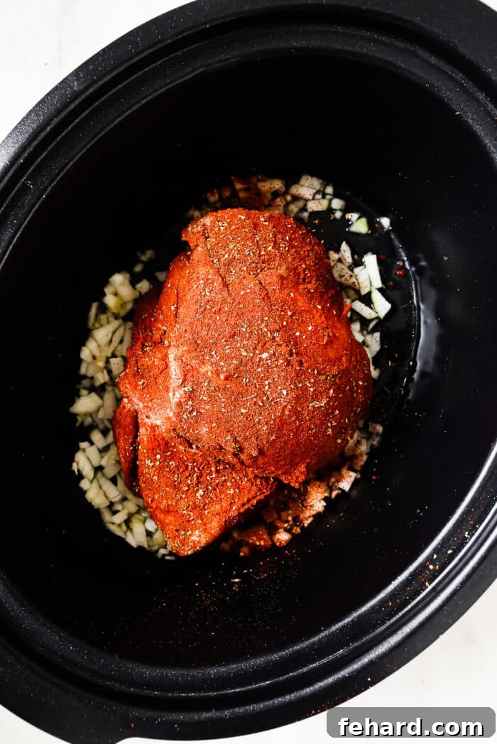 Melt-in-Your-Mouth Slow Cooker Pulled Pork 5 Seasoned pork shoulder in the slow cooker.
