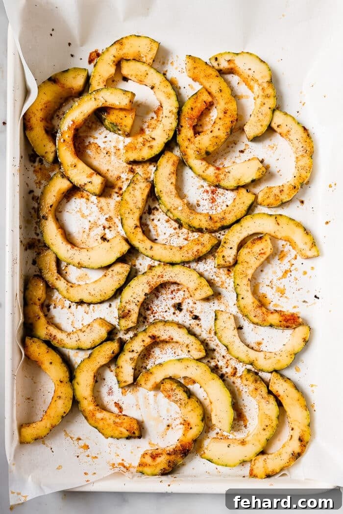 Caramelized Delicata Squash 7 Seasoned squash slices on a baking sheet.