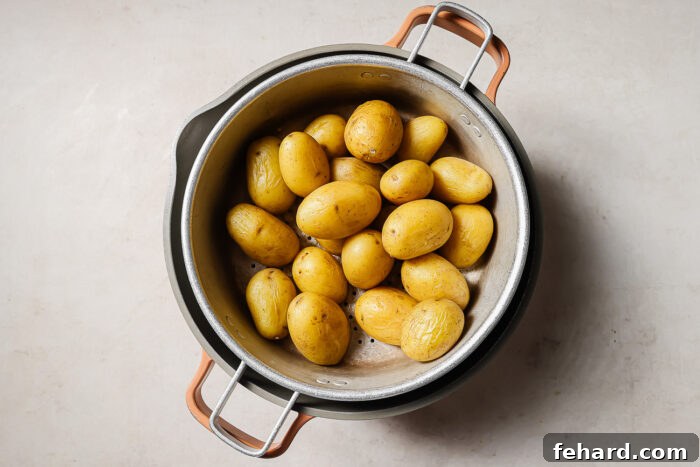 Crispy Smashed Potatoes 4 Drained baby potatoes resting in a colander after boiling, ready for the next step.