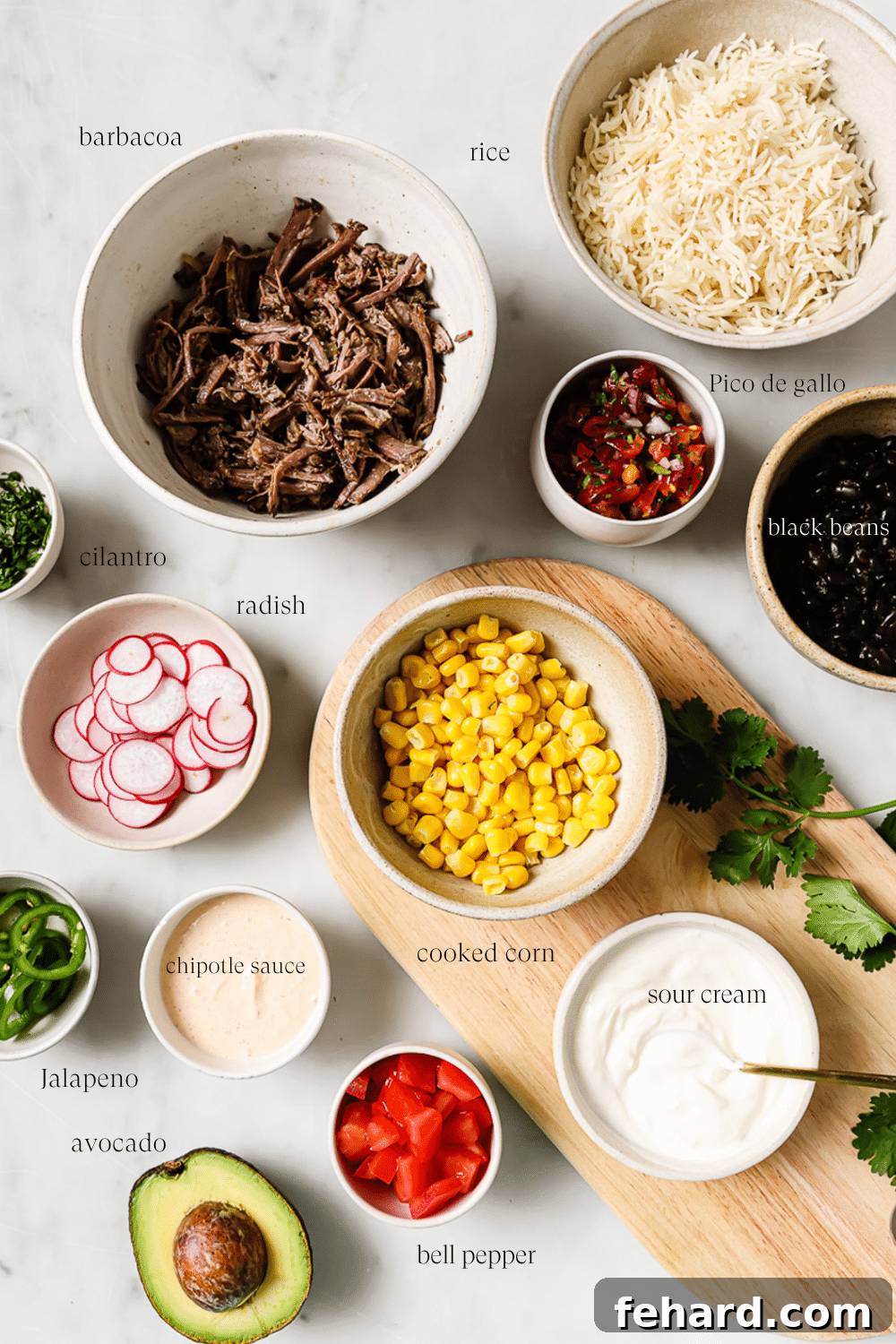 Smoky Barbacoa Bowl 3 An inviting overhead shot of various fresh ingredients prepared and neatly arranged in small, individual bowls, ready for assembly into a delicious burrito bowl.
