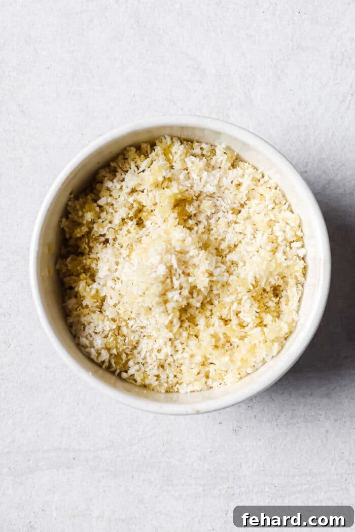 Crisp panko breadcrumbs, glistening with olive oil, in a white bowl, ready to become the perfect mac and cheese topping.