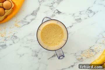 Ingredients for banana oatmeal pancakes in blender after blending.