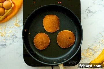 Banana Oatmeal Pancakes in skillet after being cooked.