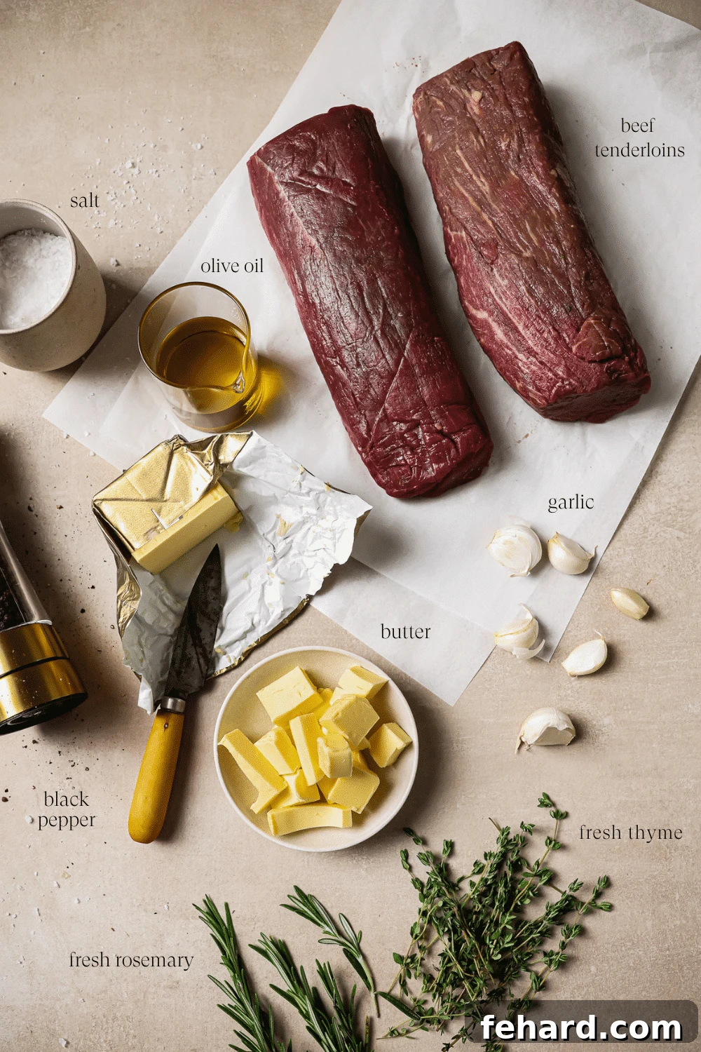 Golden Garlic Butter Tenderloin 3 An overhead view of prepped ingredients on a white countertop.
