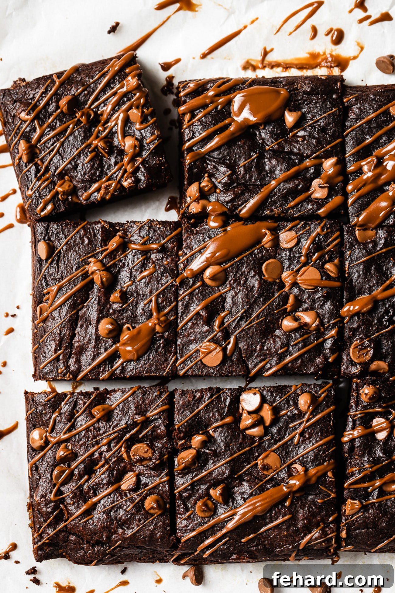 Healthy pumpkin brownies cut into squares and generously drizzled with rich chocolate sauce, ready to be enjoyed.