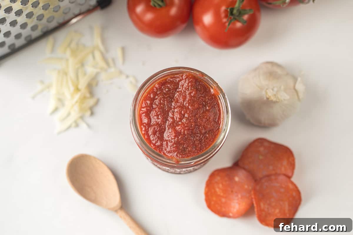 Best Homemade Pizza Sauce: Flavorful and Fresh A beautiful jar of homemade pizza sauce positioned artfully beside fresh mozzarella, vibrant basil, and spicy pepperoni, showcasing the premium ingredients.