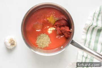 Perfect Pizza Sauce From Scratch 3 All ingredients for pizza sauce gathered in a small saucepan, ready to begin the simmering process.