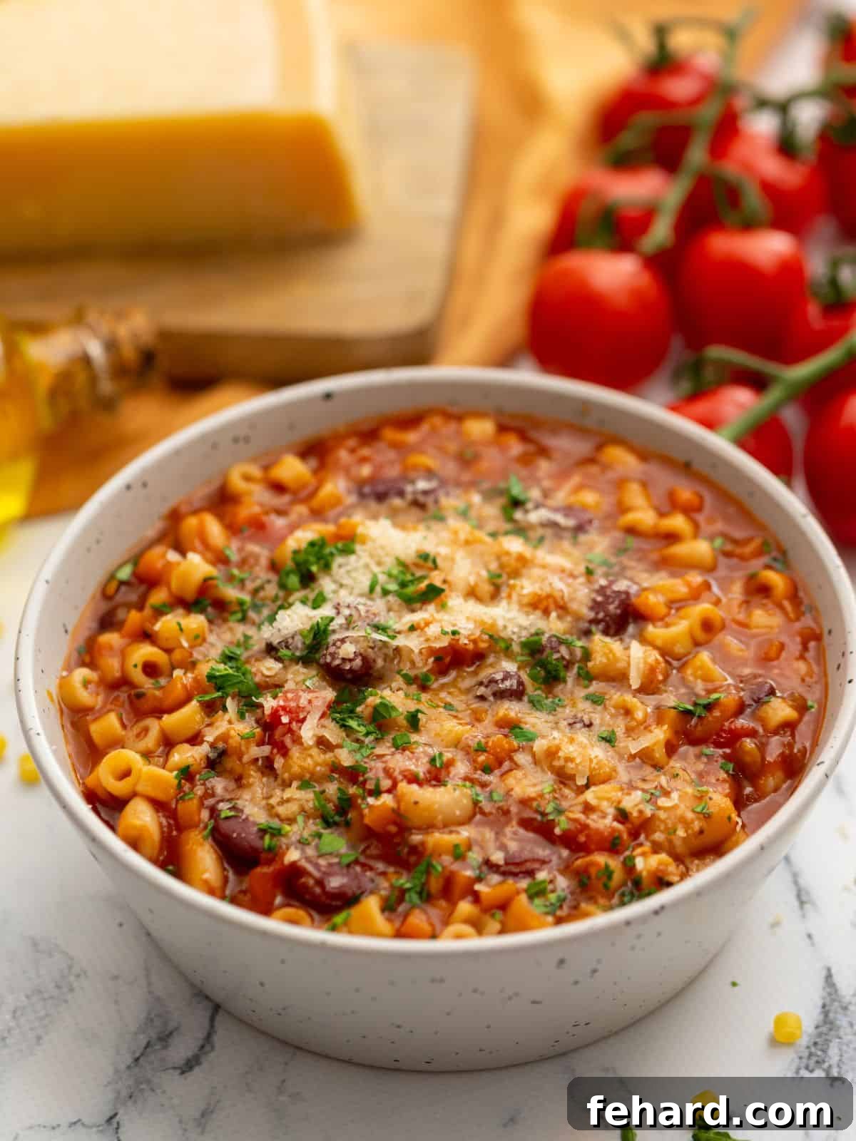 Instant Pot Pasta Fagioli - Hearty Italian Soup A steaming bowl of Instant Pot Pasta Fagioli soup, garnished with freshly grated Parmesan cheese and a sprinkle of parsley, ready to be enjoyed.