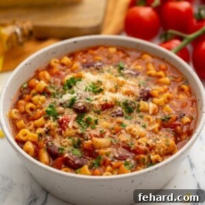 Bowl of Instant Pot pasta fagioli topped with parmesan cheese.