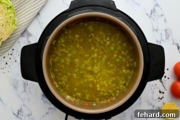 Broth poured into inner pot after sauteing veggies.
