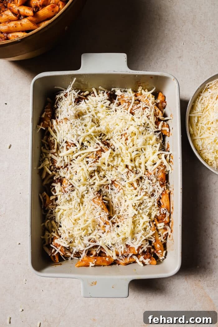 Mozzarella and Parmesan cheese is added on top of the pasta. 