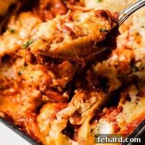 A top-down view of Stuffed Shells with Ricotta in a baking dish, freshly baked and garnished with basil.