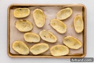 Crispy Stuffed Potato Shells 5 Potato skins on baking sheet brushed with seasoned butter.