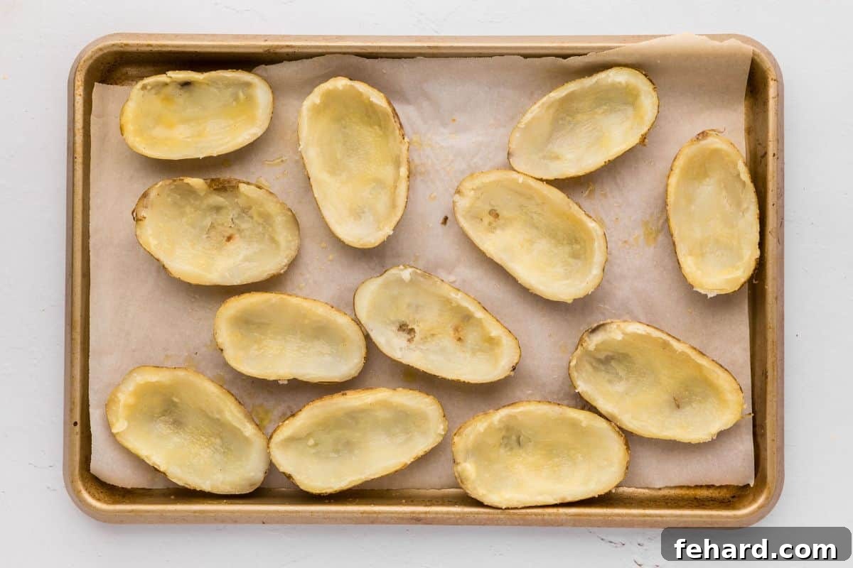 Restaurant-Quality Potato Skin Recipe Potato skins on baking sheet brushed with seasoned butter.