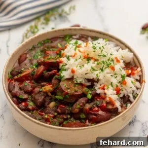 Instant Pot Red Beans and Rice served together in cream bowl topped with parsley.
