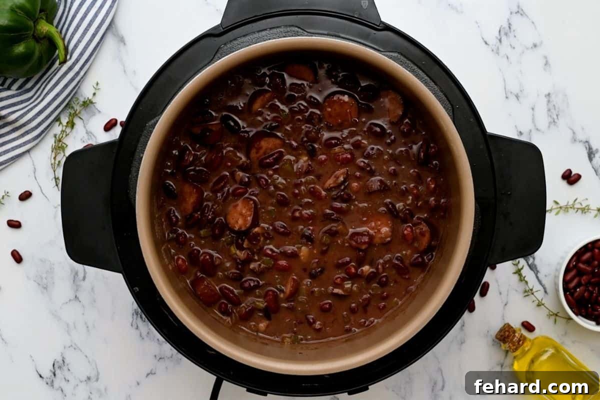 Instant Pot Red Beans cooked to a rich, thick consistency, after mashing and thickening, inside the Instant Pot.