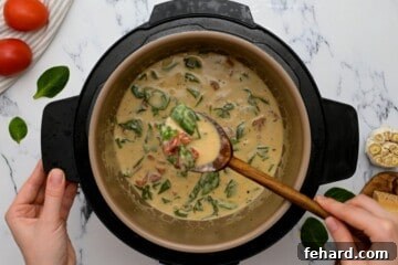 Instant Pot Chicken That Wins Hearts 5 Instant Pot inner pot filled with creamy spinach sauce and sun-dried tomatoes, thickened and ready to serve.
