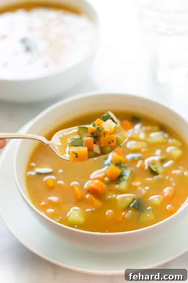 Close-up of a steaming bowl of Zucchini Summer Soup, ready to be enjoyed.