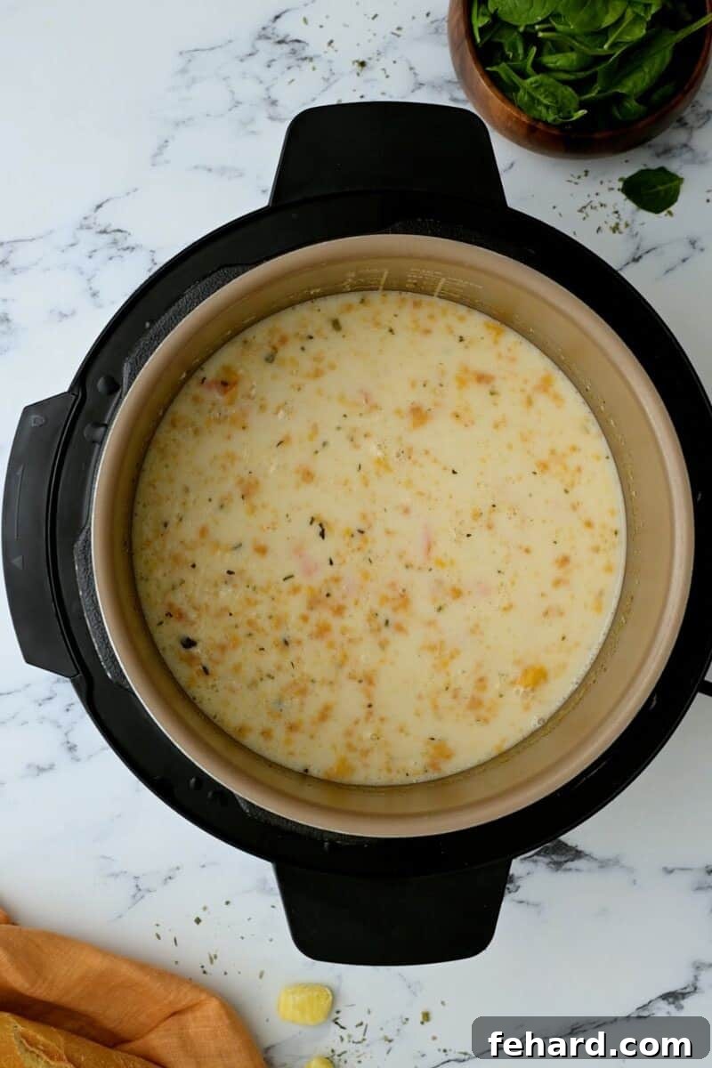 Creamy gnocchi soup simmering in the Instant Pot before adding the spinach, looking rich and inviting.