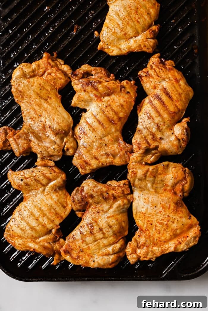 Flavor-Packed Homemade Chicken Tacos 6 Chicken thighs cooking on a grill pan.