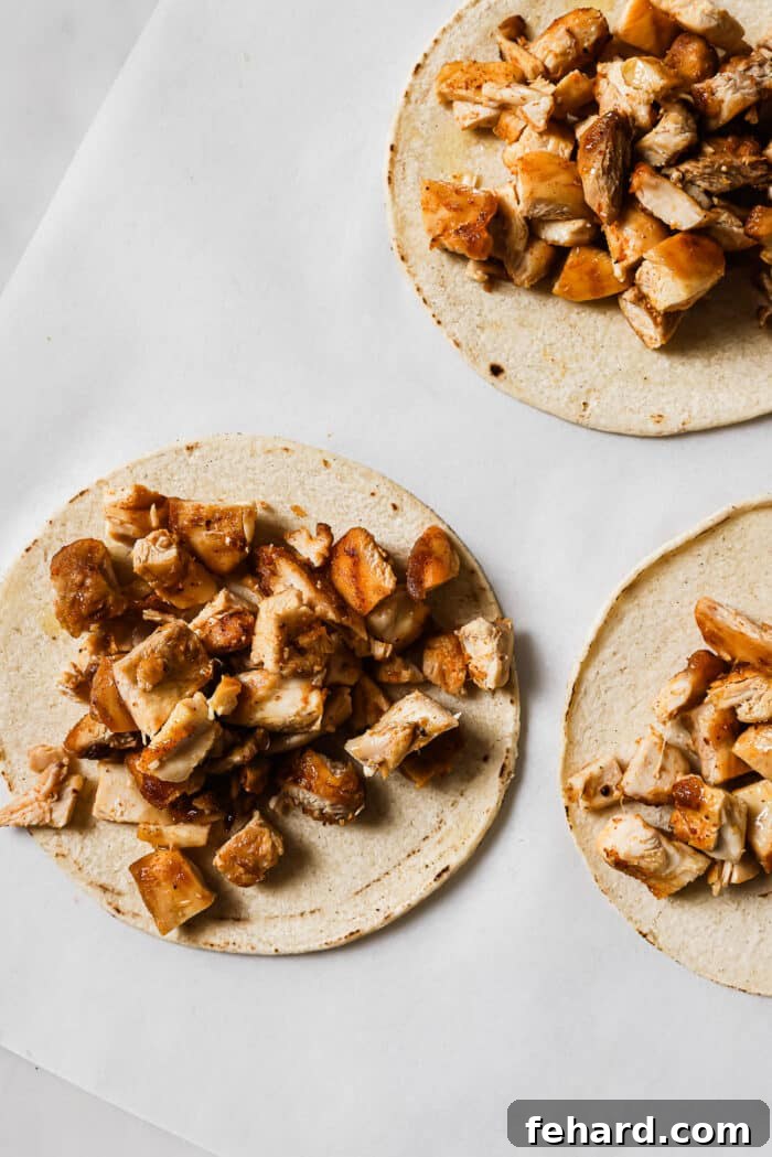 Flavor-Packed Homemade Chicken Tacos 9 Diced chicken piled on top of warm corn tortillas.