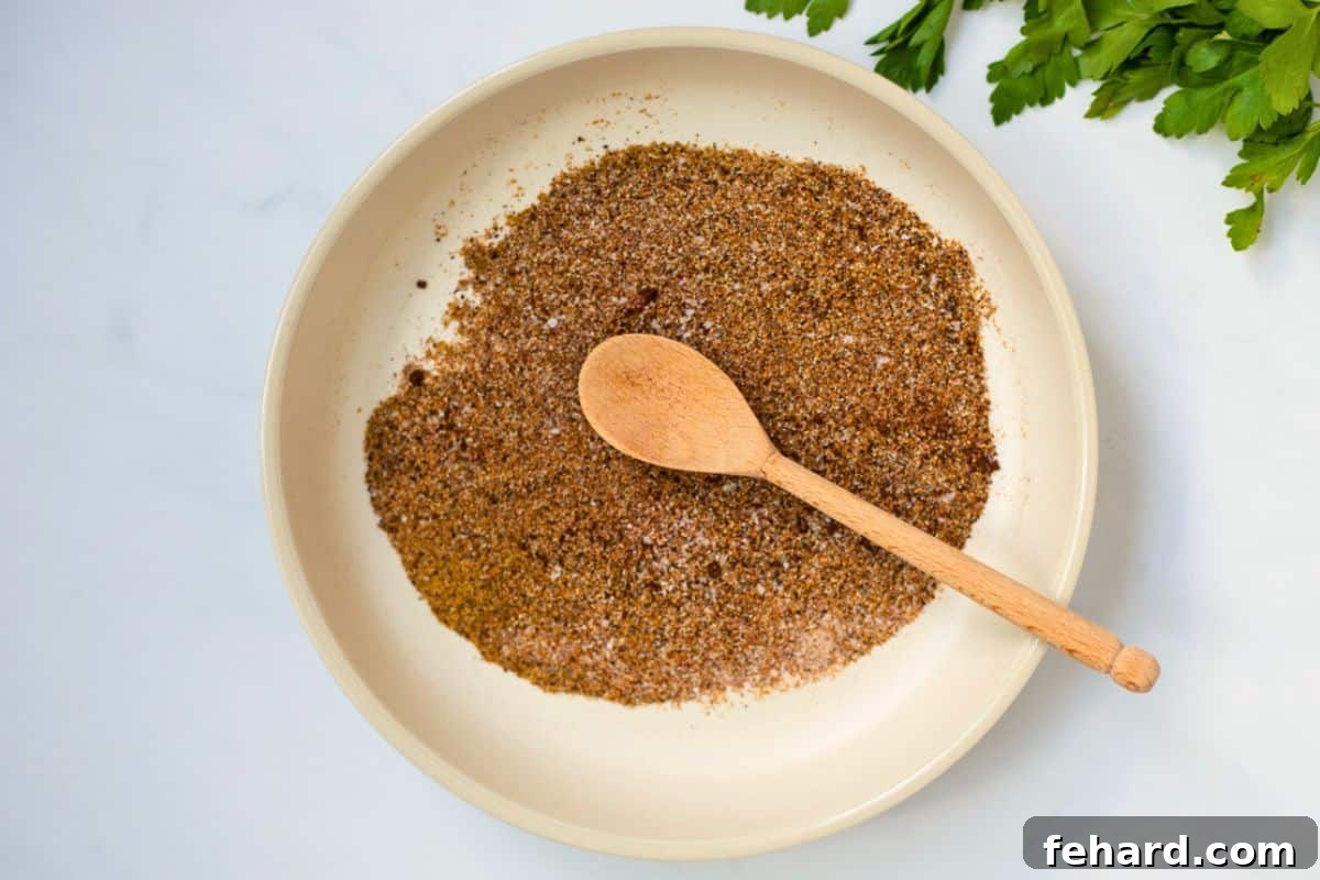 The perfectly blended chili seasoning mix resting in a small, shallow dish, showcasing its uniform texture and rich color, ready to be used or stored.