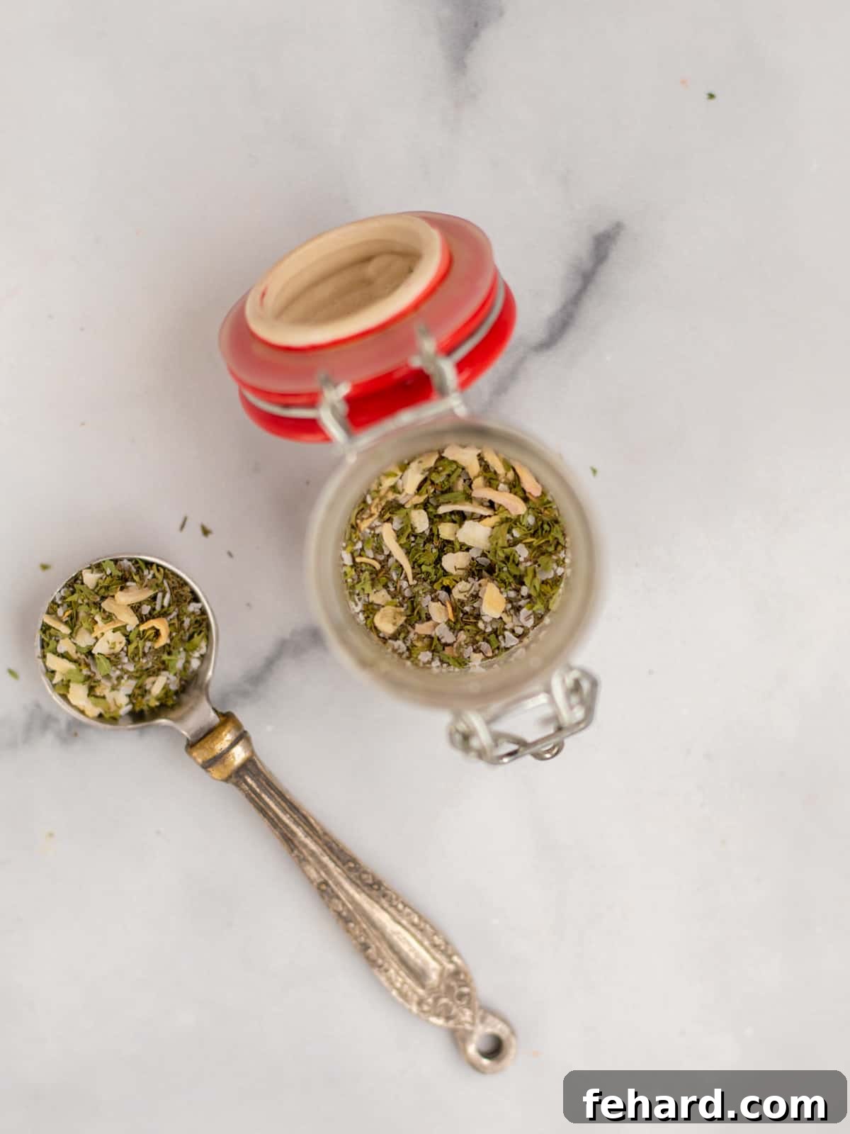 A small spice jar filled with a vibrant blend of homemade dill seasoning, ready to enhance any dish.