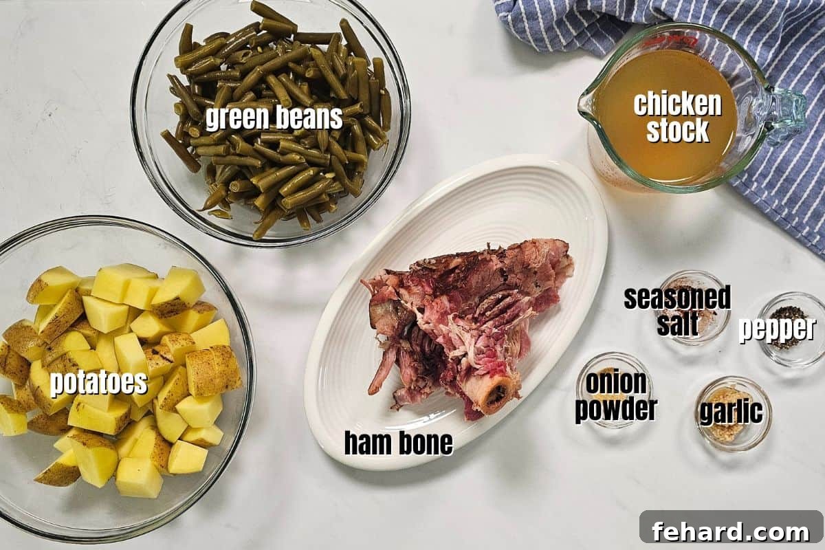 An array of fresh ingredients for slow cooker ham, potatoes, and green beans, including vibrant green beans, golden potatoes, a meaty ham bone, and various spices, neatly arranged on a clean kitchen counter.