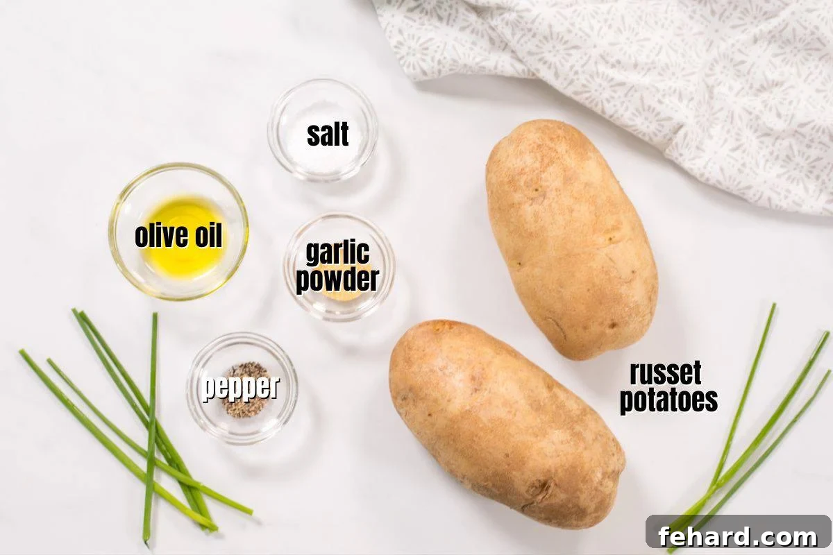 Recipe Baked Potatoes Air Fryer A selection of fresh ingredients neatly arranged on a kitchen counter, including russet potatoes, a bottle of olive oil, a small bowl of kosher salt, garlic powder, and black pepper, all set for preparing air fryer baked potatoes.