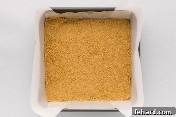 Zesty Lemon Cheesecake Bars 5 Graham cracker crust pressed into 8x8 baking pan lined with parchment paper.