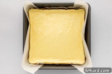 Zesty Lemon Cheesecake Bars 8 Baked lemon cheesecake bars in 8x8 baking dish after baking bars.