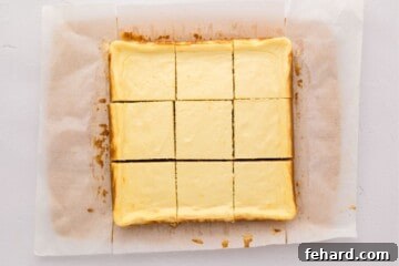 Zesty Lemon Cheesecake Bars 9 Lemon Cheesecake Bars after being removed from baking pan and cut into 12 wedges.