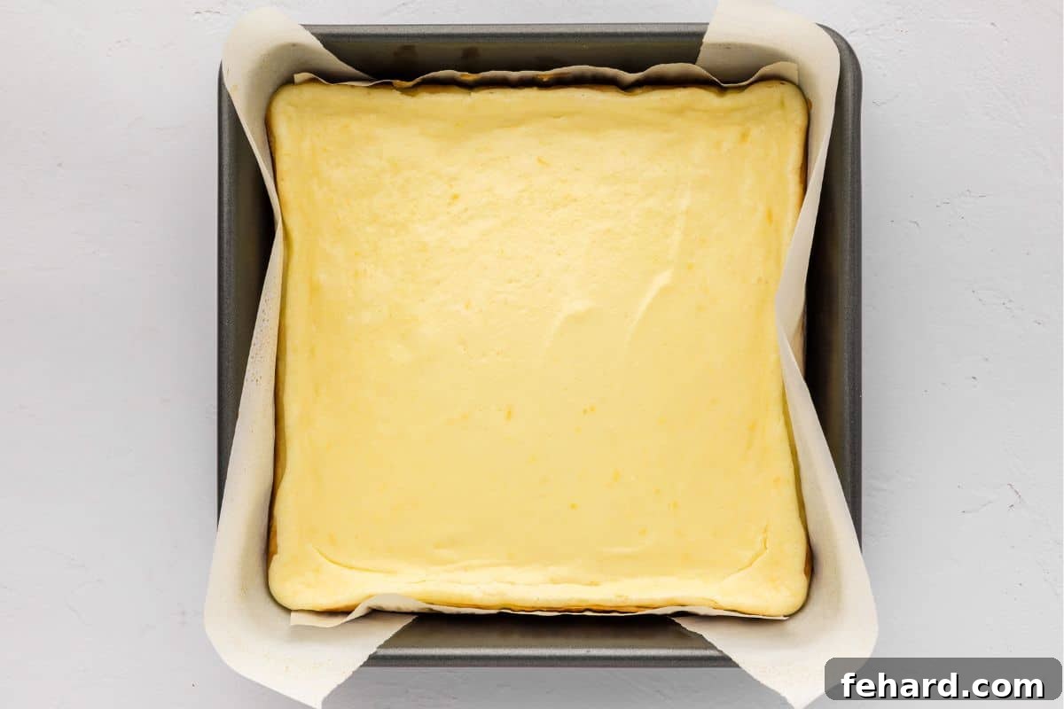Lemon Cream Cheese Bar Recipe Baked lemon cheesecake bars in 8x8 baking dish after baking bars.
