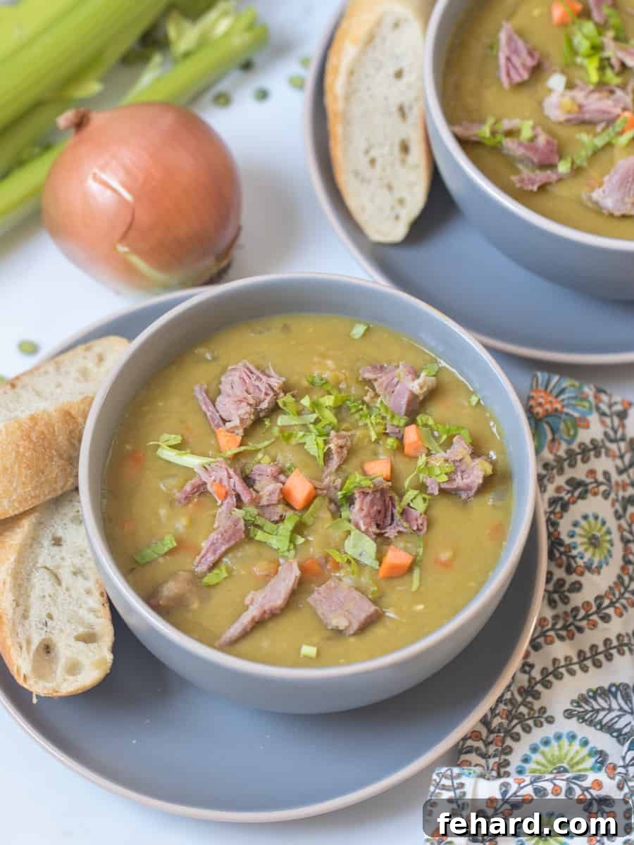 Instant Pot Split Pea Soup Recipe A steaming bowl of Instant Pot split pea soup, garnished with fresh herbs and diced ham, served alongside crusty artisan bread on a rustic wooden surface.