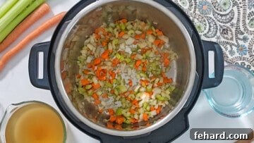 Hearty Instant Pot Split Pea Soup 3 Sauteed carrots, onions, and celery inside inner pot.
