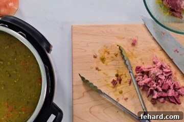 Hearty Instant Pot Split Pea Soup 7 Split pea soup inside inner pot with diced ham on cutting board.