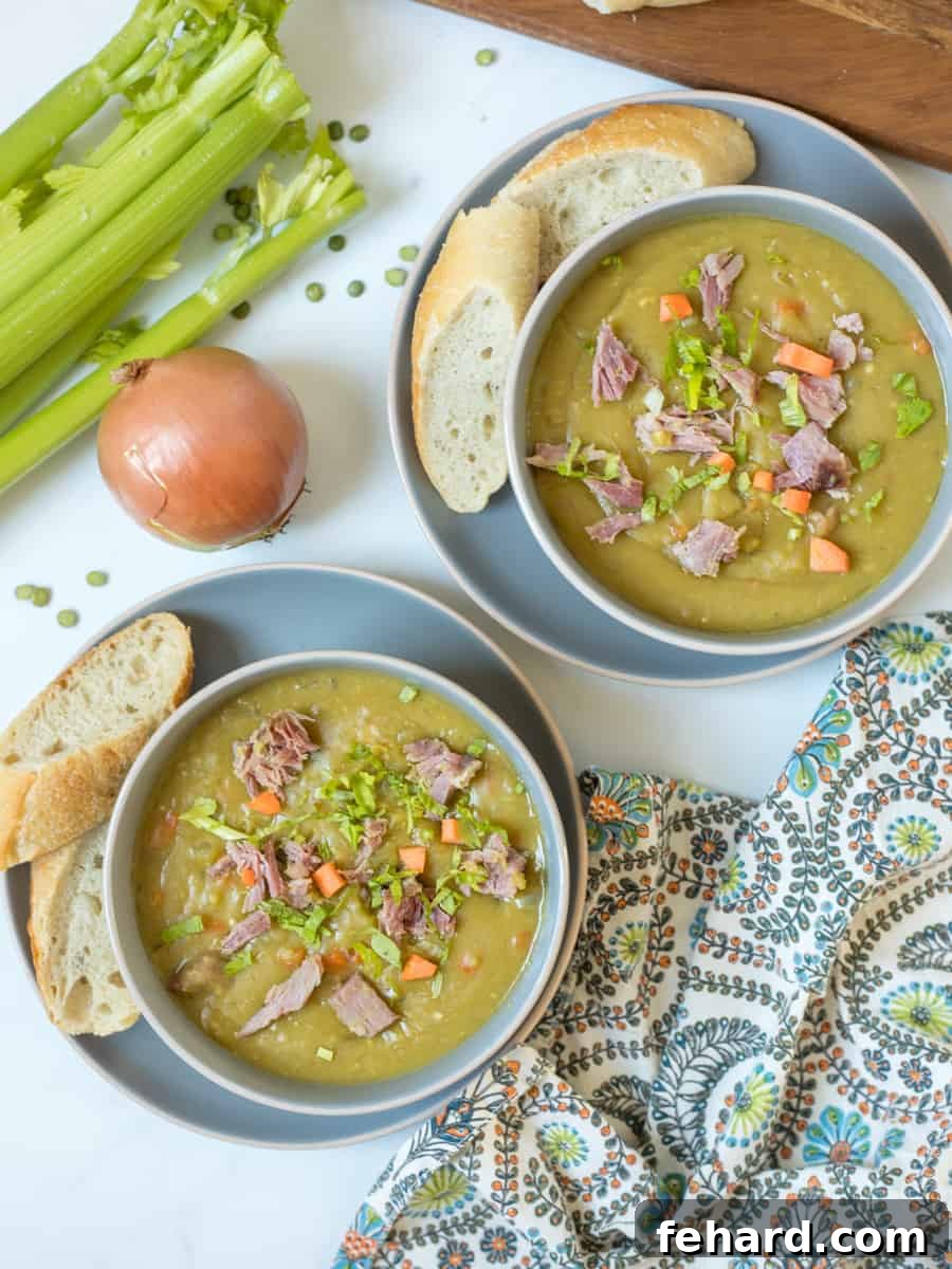 Serving Instant Pot Split Pea Soup Two inviting bowls of Instant Pot split pea soup, generously topped with diced ham and fresh carrots, served side-by-side with slices of crusty artisan bread, ready for a comforting meal.