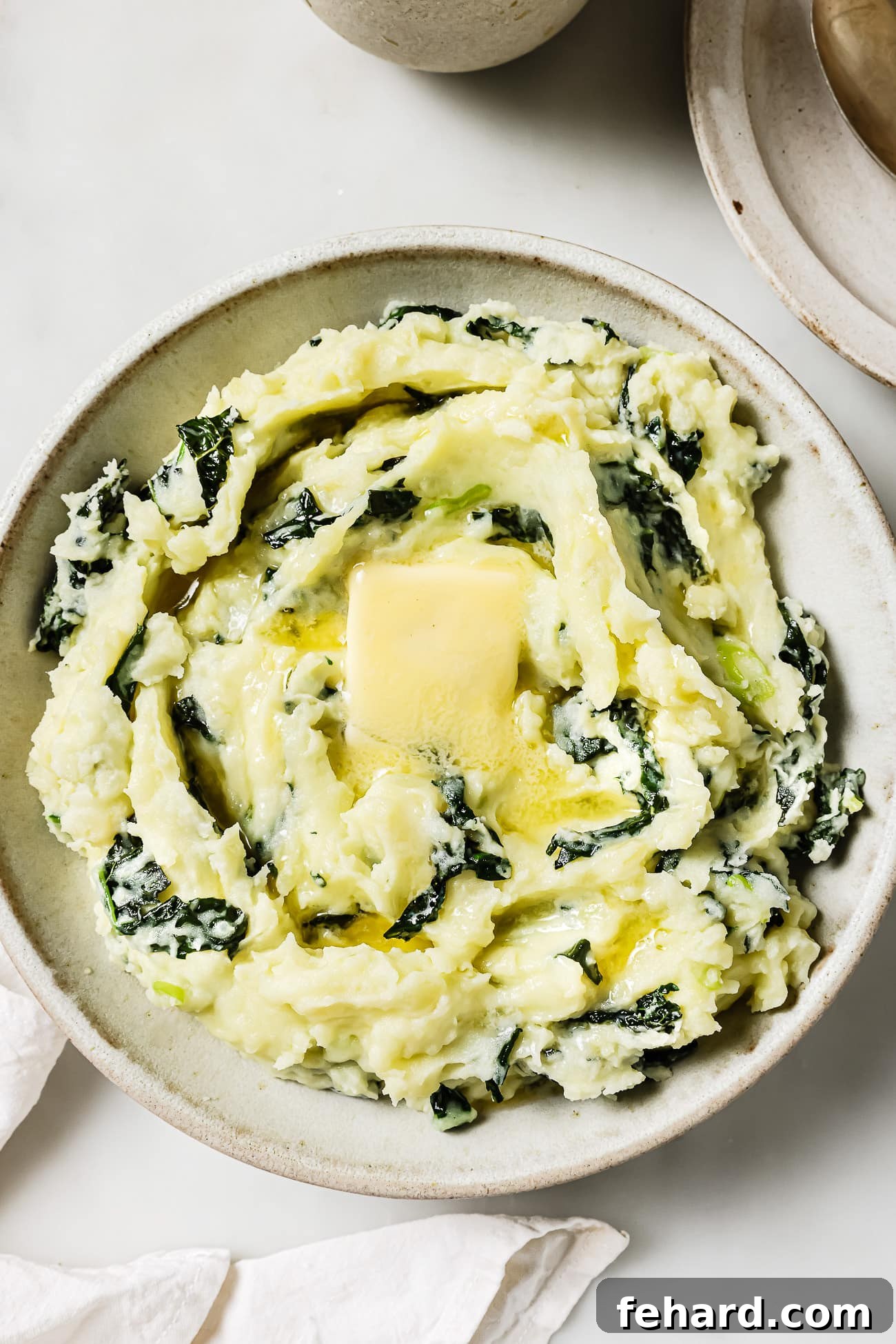 Irish Comfort Colcannon 2 overhead view of colcannon in a bowl, garnished with a pat of butter