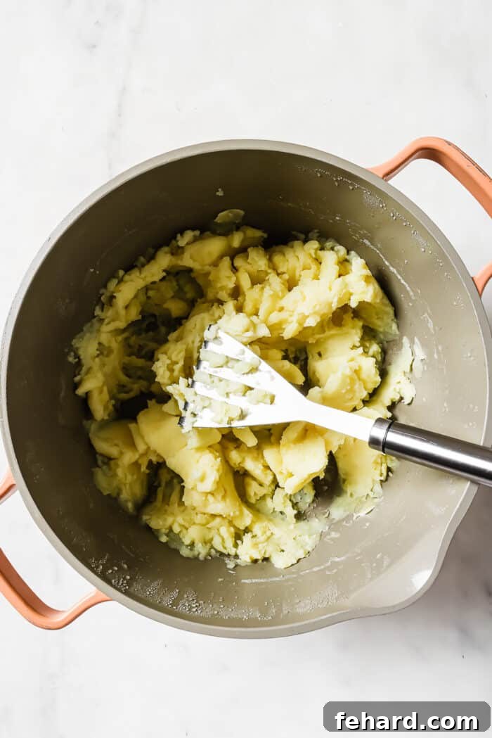Irish Comfort Colcannon 6 A large pot of mashed potatoes on a white countertop.