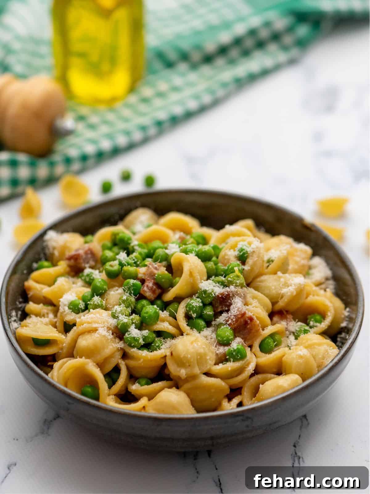 Pasta with Peas and Pancetta A beautifully plated bowl of Pasta with Peas, pancetta, and freshly grated Parmesan cheese, ready to be enjoyed.