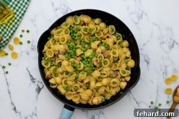 Spring Pea Pasta 6 Pasta, peas, pancetta, and Parmesan cheese tossed together in a skillet, creating a creamy and vibrant dish.