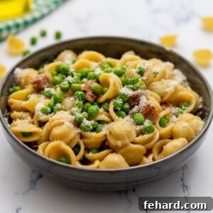 Spring Pea Pasta 2 Bowl of pasta with peas, pancetta, and parmesan, beautifully garnished.