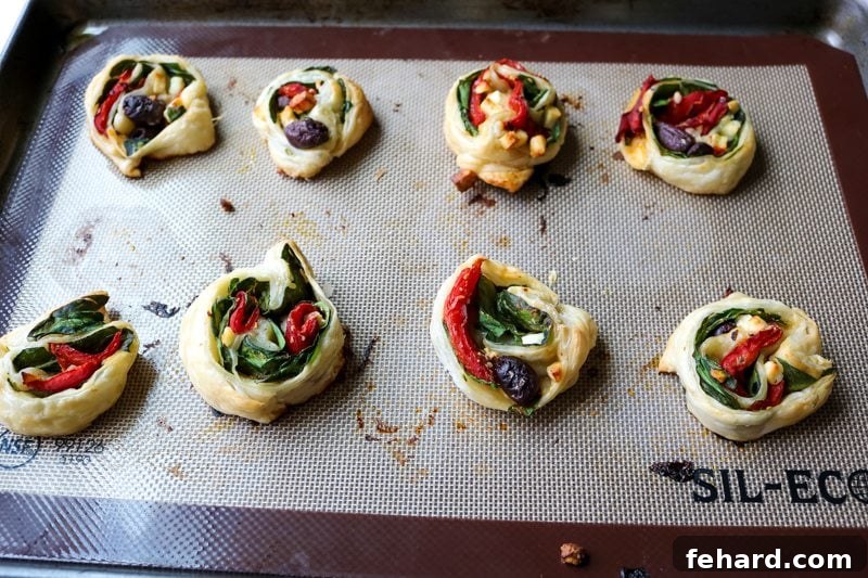 Golden Greek Rolls Baked Greek Pinwheels cooling on a baking sheet, golden and crisp.
