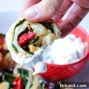 Mediterranean Feta & Herb Swirls 2 Greek pinwheel recipe being dipped into Tzatziki sauce.