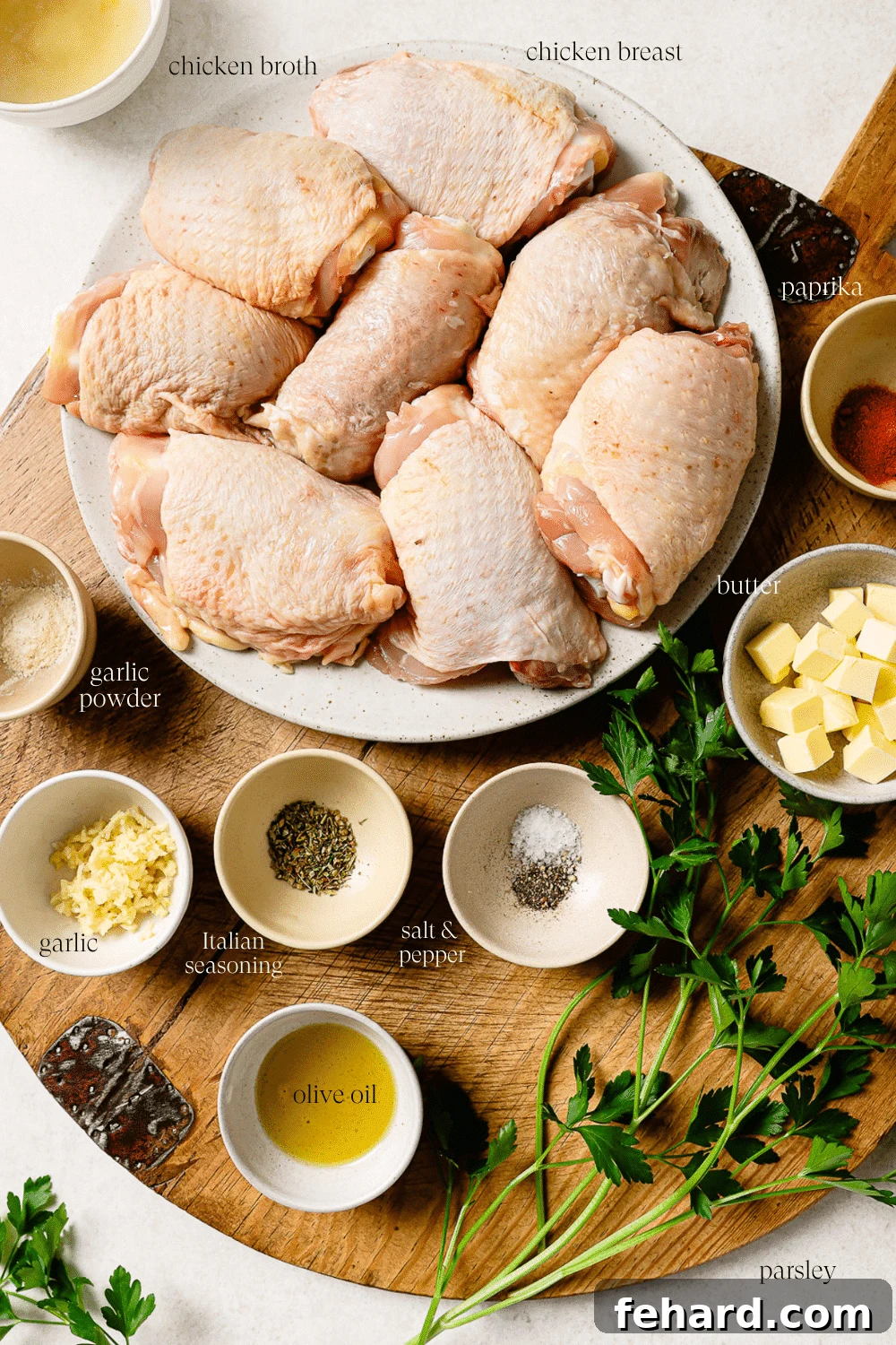 Pre-measured ingredients for slow cooker chicken thighs on a wooden cutting board. 