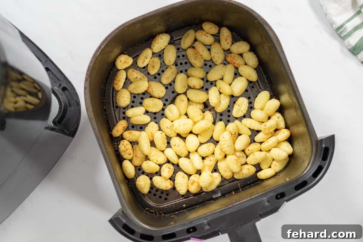 Gnocchi Air Fryer Cooking Crispy Air Fried Gnocchi in basket after air frying.